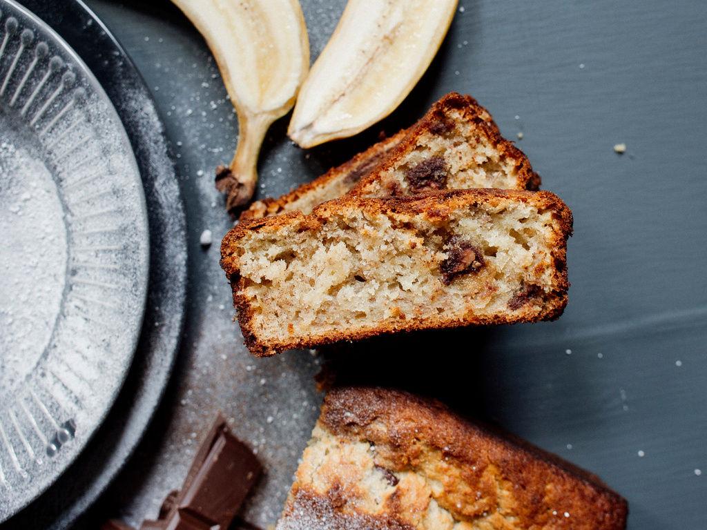 Tasty banana bread slices on table